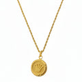 Gold necklace with a round pendant on a white background