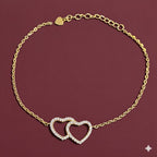 Gold bracelet with interlocking heart charms on a red background