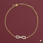 Gold bracelet with heart charm on wrist against a neutral background