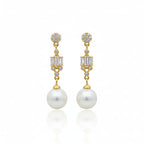 Gold earrings with pearls and gemstones on a white background