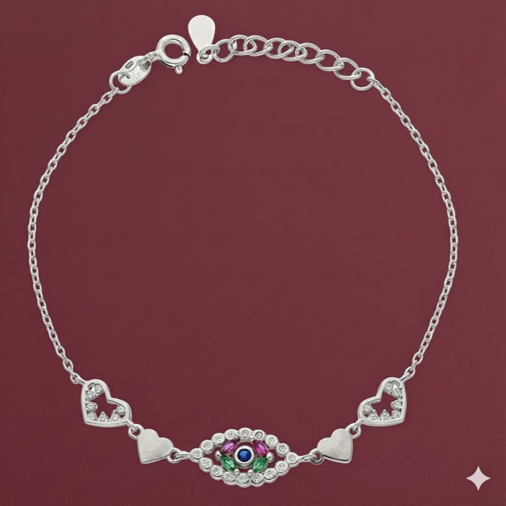 Silver bracelet with heart and eye design on a maroon background