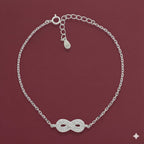 Silver bracelet with an infinity symbol on a red background