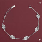 Silver bracelet with diamond-like stones on a maroon background