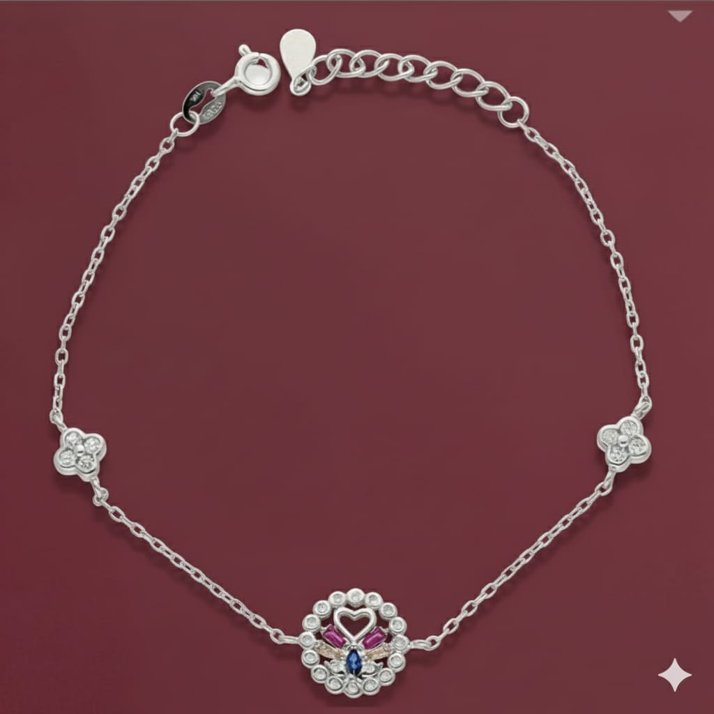 Silver bracelet with a decorative clasp on a maroon background