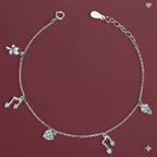 Silver bracelet with charms on a maroon background