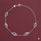 Silver bracelet with leaf-shaped links on a maroon background
