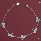 Silver bracelet with floral designs on a red background
