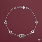 Silver heart-shaped bracelet on a red background