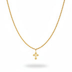 Gold necklace with cross pendant on a black velvet stand