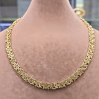 Gold necklace on a mannequin with weight and length information displayed.