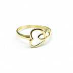 Gold ring with heart design on a gray background