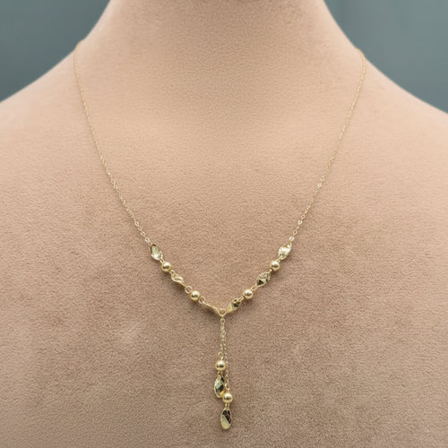 Gold necklace on a mannequin with close-up inset and weight label.