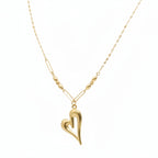 Gold necklace with a heart pendant on a mannequin neck, showing weight and carbon dating information.