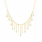 Delicate gold necklace on a mannequin with weight and code information.