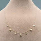 Necklace with star pendants on a mannequin neck, labeled with weight and code.
