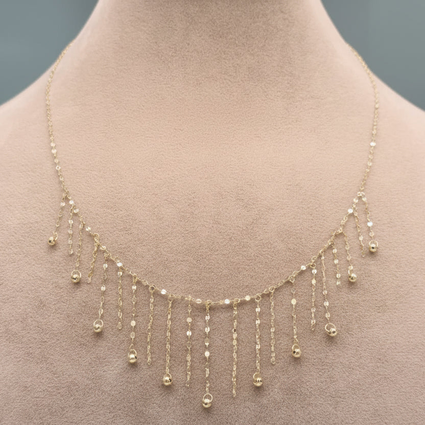 Gold necklace on a mannequin with weight label '1.28g C-14'.