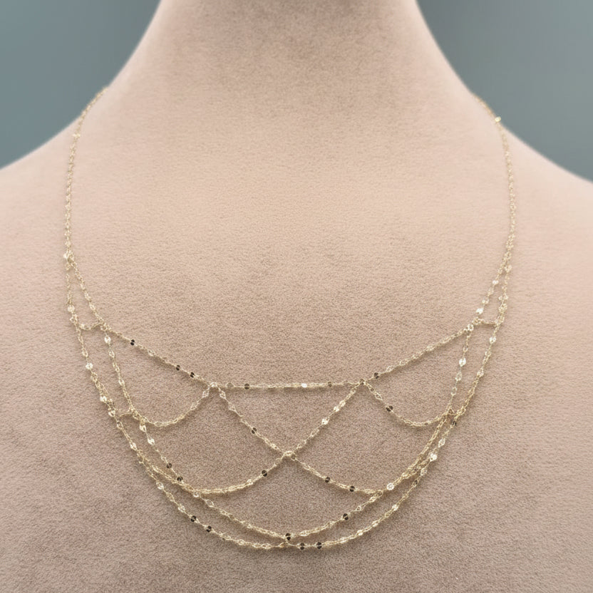 Gold necklace on a mannequin with weight and code information displayed.