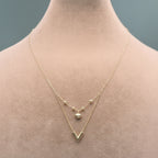 Gold necklace on a mannequin with weight and material information displayed.