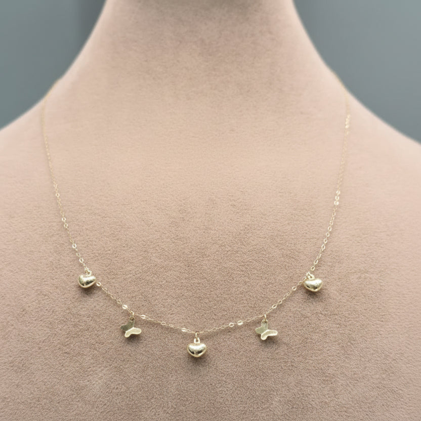 Gold necklace on a mannequin with weight and code displayed