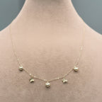 Gold necklace on a mannequin with weight and code displayed