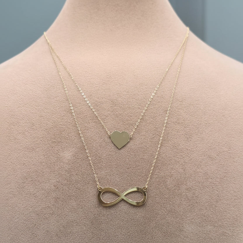 Gold bracelet with infinity pendant on a mannequin