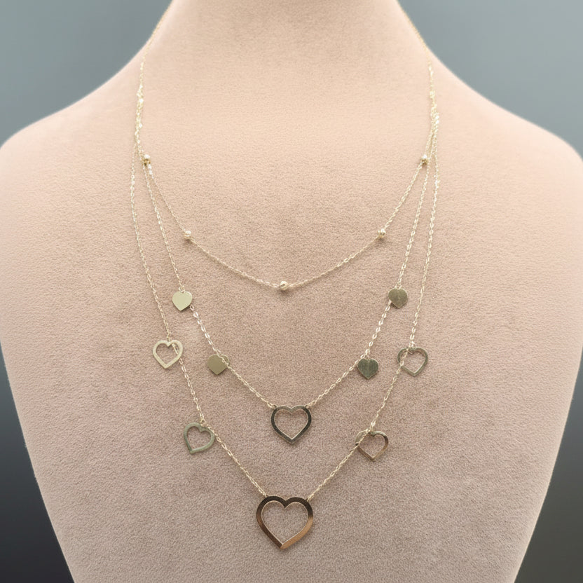 Necklace with heart pendants on a mannequin bust, showing weight and code.