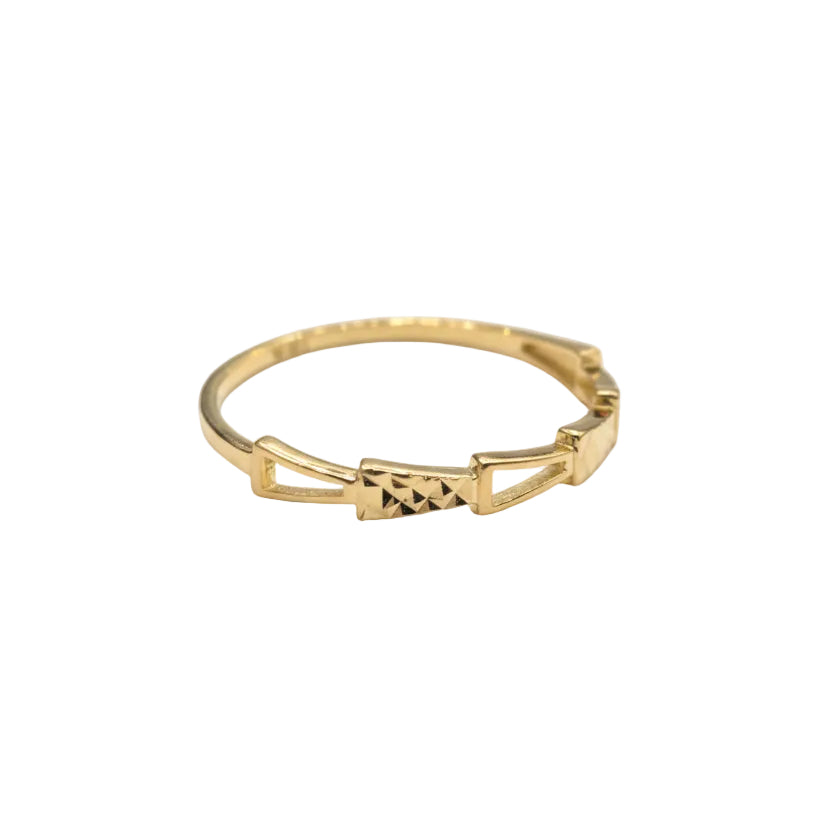 Gold ring with geometric design on a gray background
