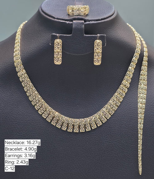 Gold necklace, bracelet, and earrings on a black mannequin with weight labels.
