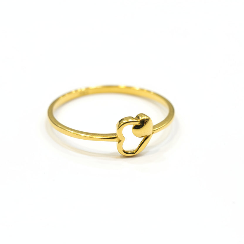 Gold ring with a heart design on a gray background