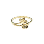 Gold ring with floral design on a gray background
