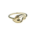 Gold ring with a heart design on a gray background