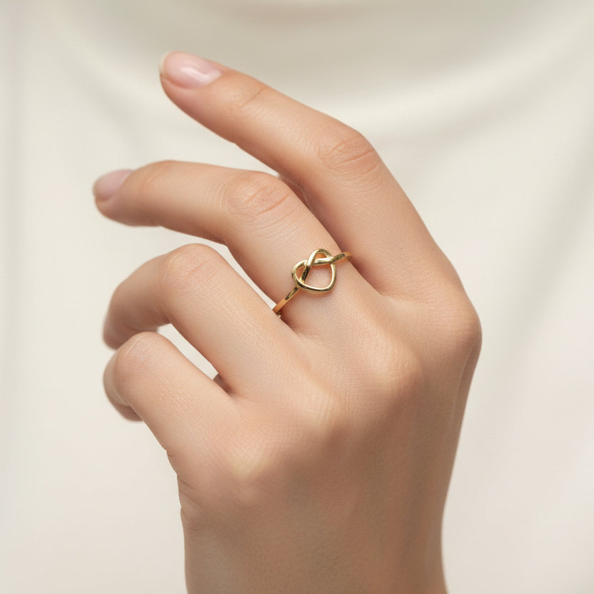 Gold infinity ring on a white background