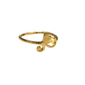 Gold ring with heart design on a gray background