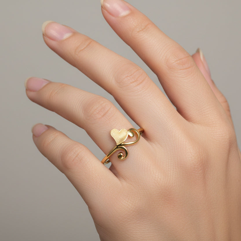 Gold ring with a unique design on a white background