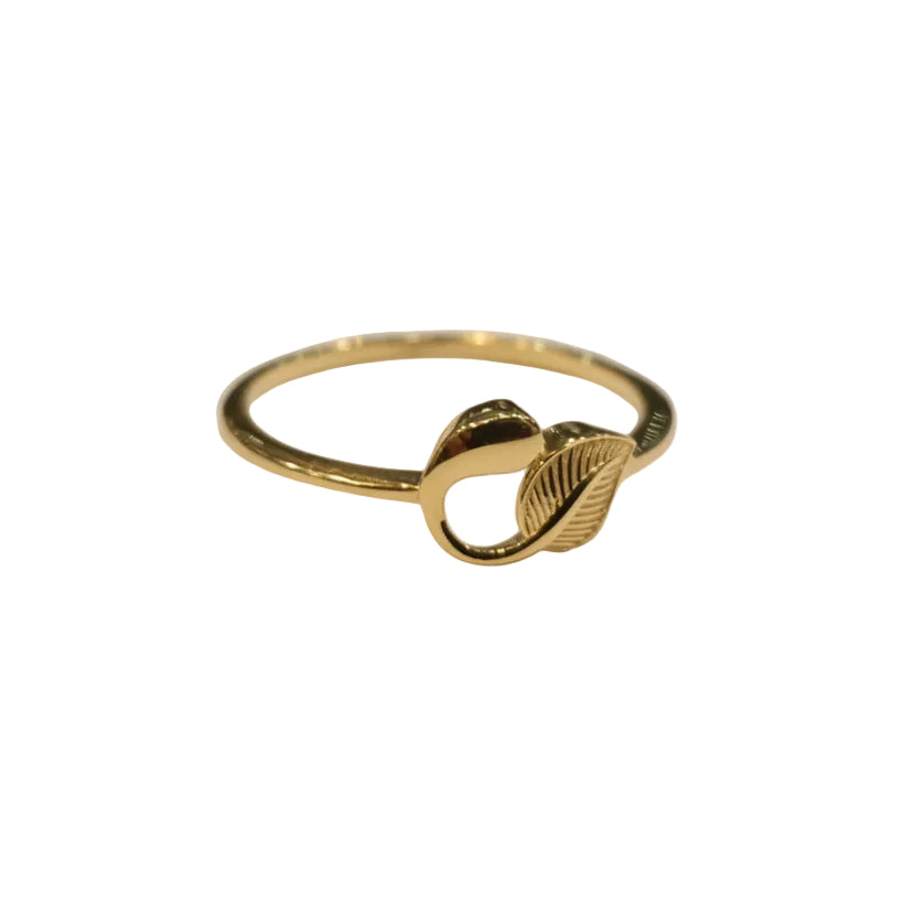 Gold ring with leaf design on a gray background