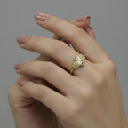 Gold ring with geometric design on a gray background