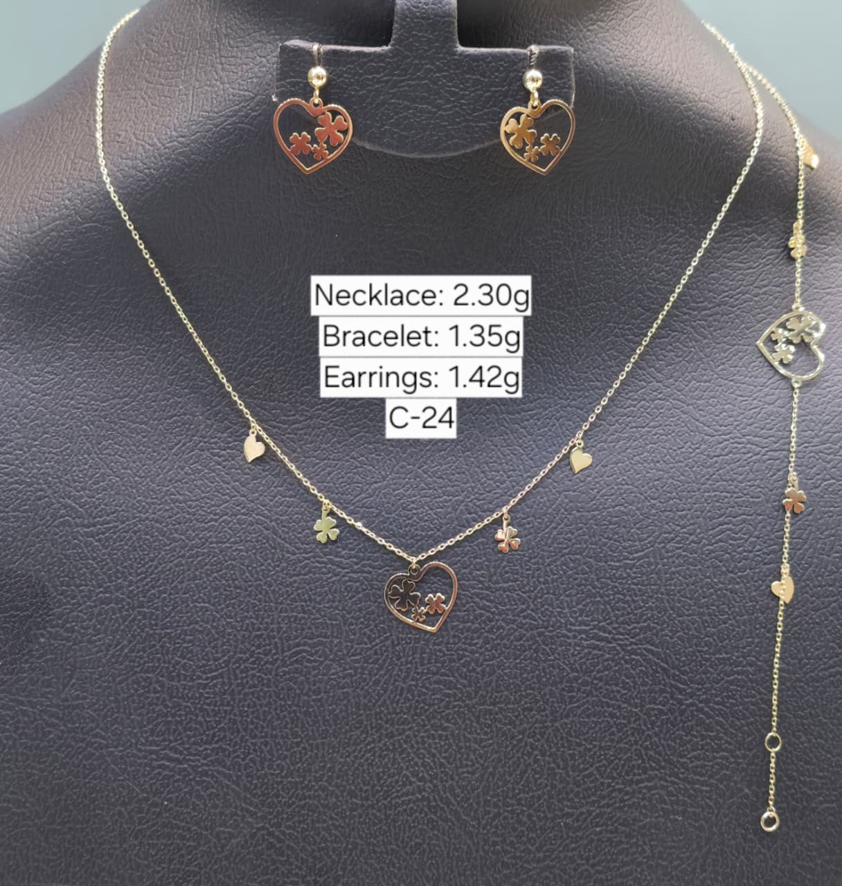 Jewelry set with necklace, bracelet, and earrings on a dark gray background