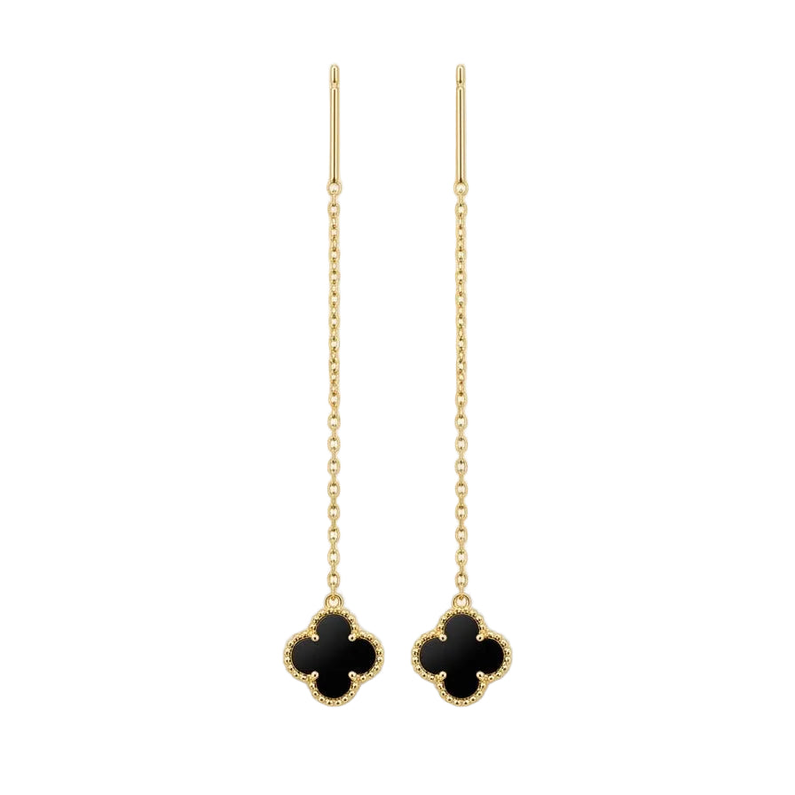 Pair of gold earrings with black clover-like charms on a white background