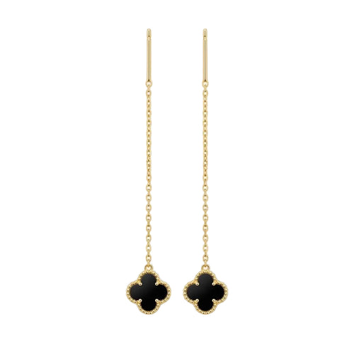 Pair of gold earrings with black clover-like charms on a white background