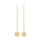 Gold earrings with round pendants on thin chains against a white background