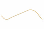Gold chain on a black surface with a visible brand label.