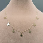 Butterfly necklace on a mannequin with weight label