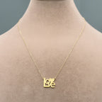 Gold necklace with 'LOVE' pendant on a mannequin, weight 1.11g, code C-43.