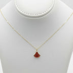 Necklace with a red pendant on a beige mannequin bust against a white background