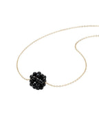 Necklace with a black floral pendant on a white background