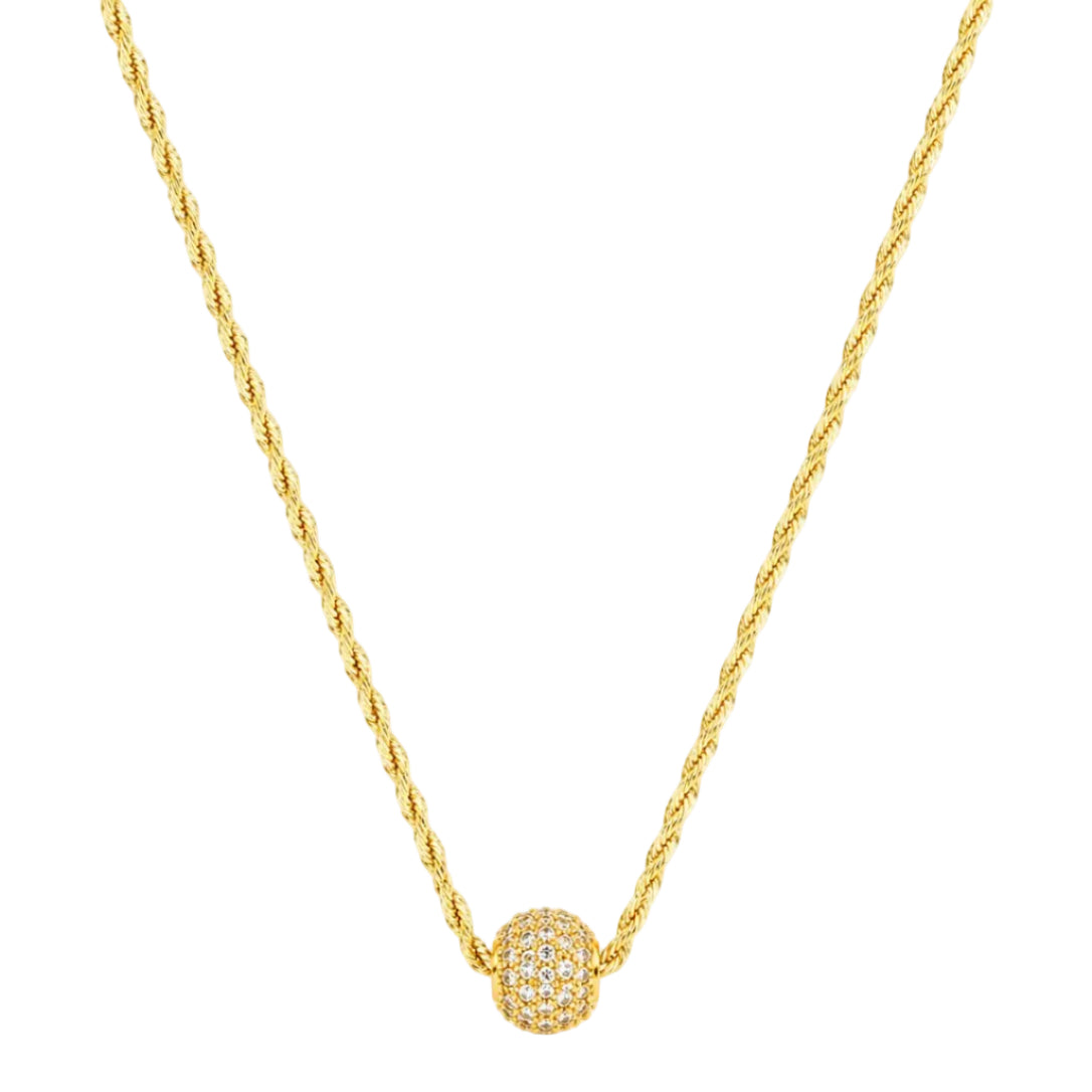 Gold necklace with a spherical pendant on a white background