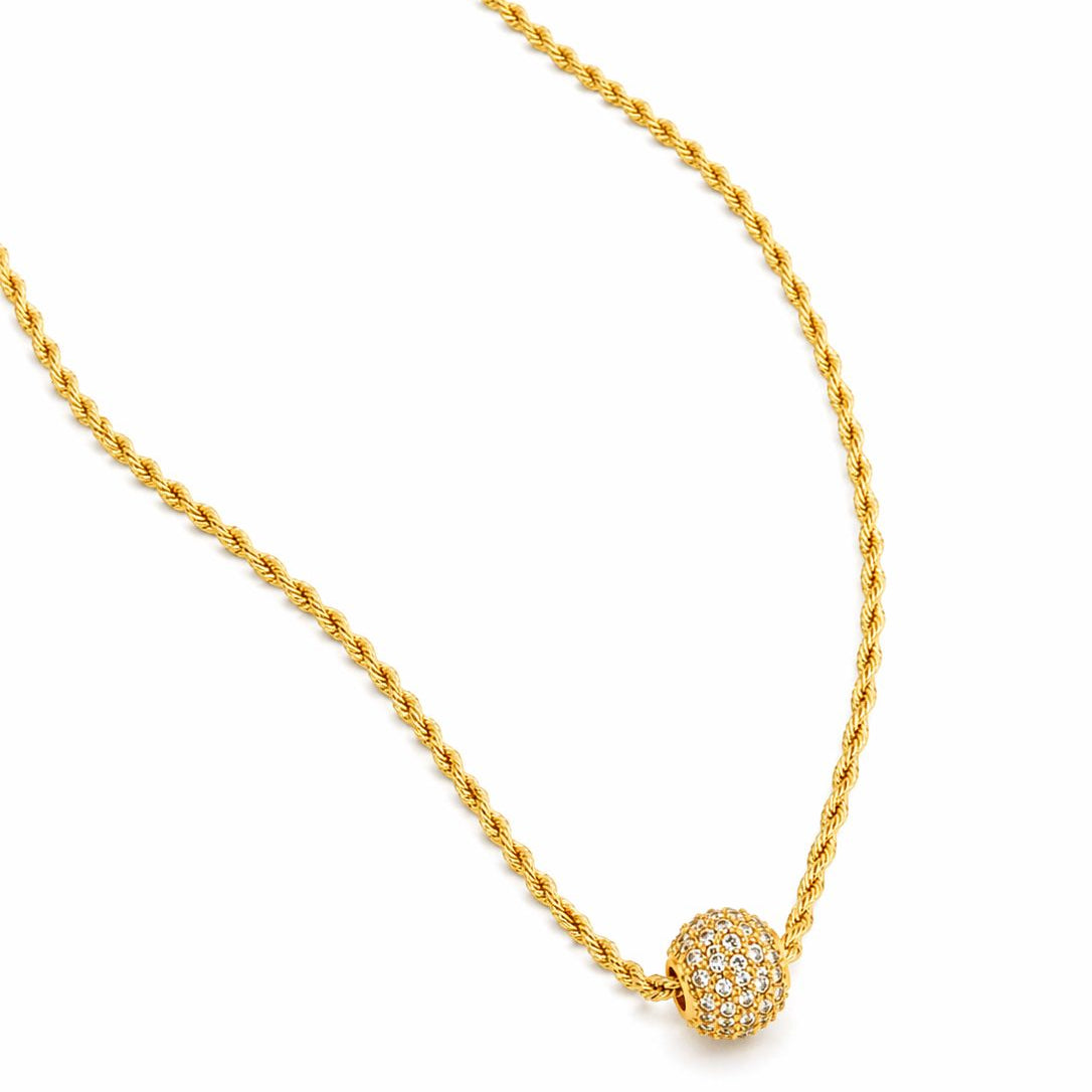 Gold necklace with a round pendant on a white background