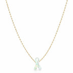 Necklace with a white ribbon pendant on a gold chain against a white background
