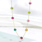 Necklace with colorful beads on a white background