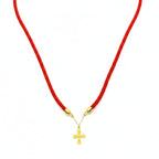 Red cord necklace with a gold cross pendant on a white background
